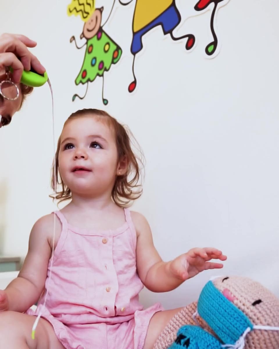 A smiling toddler during a friendly check-up at American Pediatrics